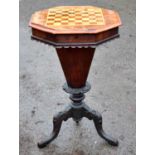 A Victorian walnut 'trumpet' chess top sewing table with hexagonal tapering central column to