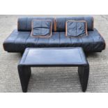 20TH CENTURY DESIGN; a Tetrad type 1970s black leather designer sofa with stool/table, width 202cm.