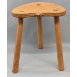 ROBERT 'MOUSEMAN' THOMPSON; an oak milking stool with trademark carved mouse, height 45cm.