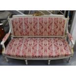 An early 20th century white and gilt painted French settee re-upholstered in red and yellow