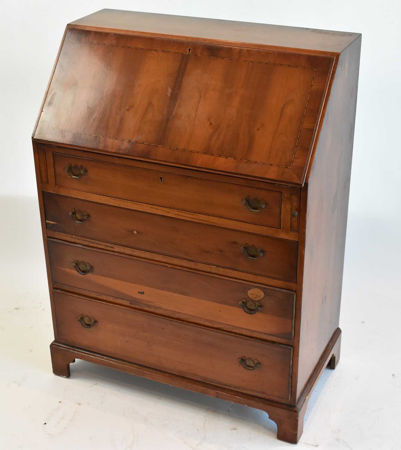 A reproduction yew wood four drawer bureau, width 73cm.