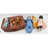 A suitcase containing vintage toys including a black doll Mandy Lou, and two further dolls, teddy