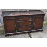 An early 20th century oak sideboard with three central drawers flanked by doors, width 152cm.