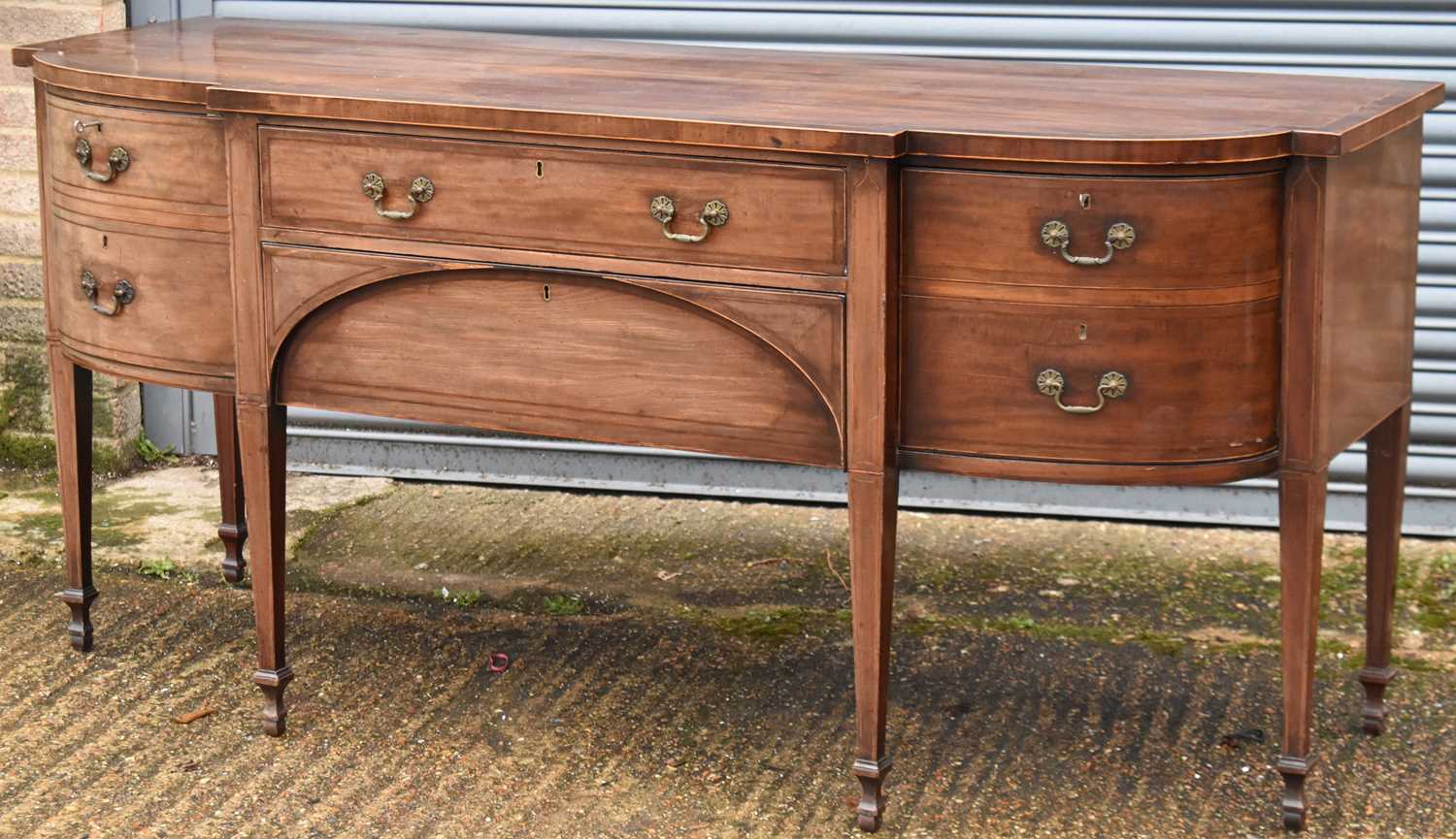 A large 19th century mahogany sideboard, the crossbanded and boxwood strung top above two central