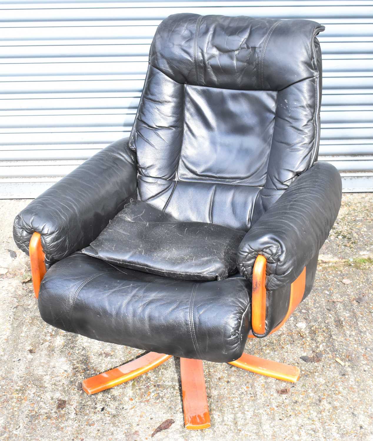 A modern black leather adjustable armchair.