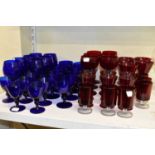 A collection of coloured glass including seven Bristol Blue glass goblets, fifteen small wine