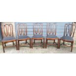 A set of five Georgian mahogany dining chairs with serpentine seats and square supports.