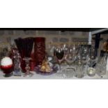 Two shelves of mixed glassware including white wine glass, champagne glasses, dessert bowls, further