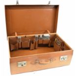 A fine leather travelling vanity set with part fitted interior including four silver mounted