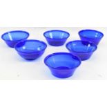 A set of five blue glass bowls, and another similar (6).