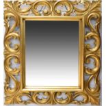 A decorative ornate gilt framed rectangular wall mirror with bevelled plate, 63 x 54cm.