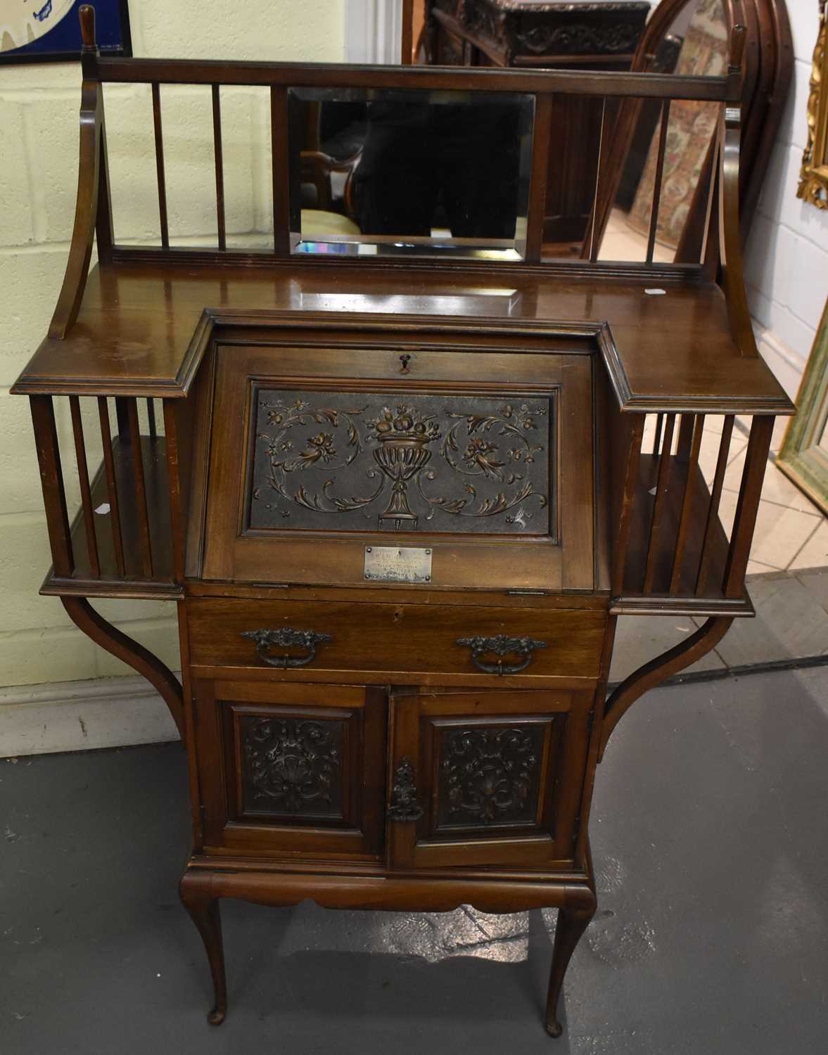 A late Victorian mahogany bureau of small size, with bevelled mirror inset to the back above fall