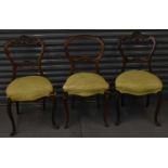 A pair of Victorian walnut balloon back chairs and another (3).