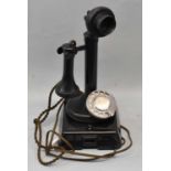 A vintage candlestick telephone with bell box.