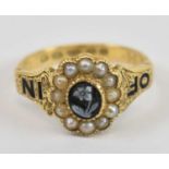 A 19th century 18ct yellow gold seed pearl and cameo mourning ring with central floral carved oval