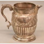 JAMES STAMP; a George III hallmarked silver jug with urn and swag decoration and part fluted body,