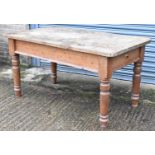 A rectangular kitchen table, the burr wood top on turned pine supports with end drawer, 153 x 83.