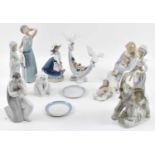 LLADRO; eight figures including polar bear, doves holding a basket of flowers, two dishes, and