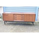 A mid-century sideboard with three central drawers flanked by two cupboard doors, width 191cm.