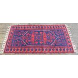 A Kurdish style red ground rug with geometric designs, 189 x 100cm.