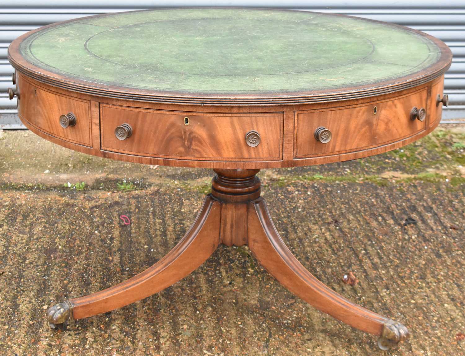 A Regency style mahogany drum-top library table, with green leather inset above crossbanded