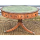 A Regency style mahogany drum-top library table, with green leather inset above crossbanded