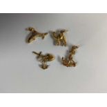 A small group of 18ct gold charms comprising a camel, anchor, fish, and a heart, cross and anchor