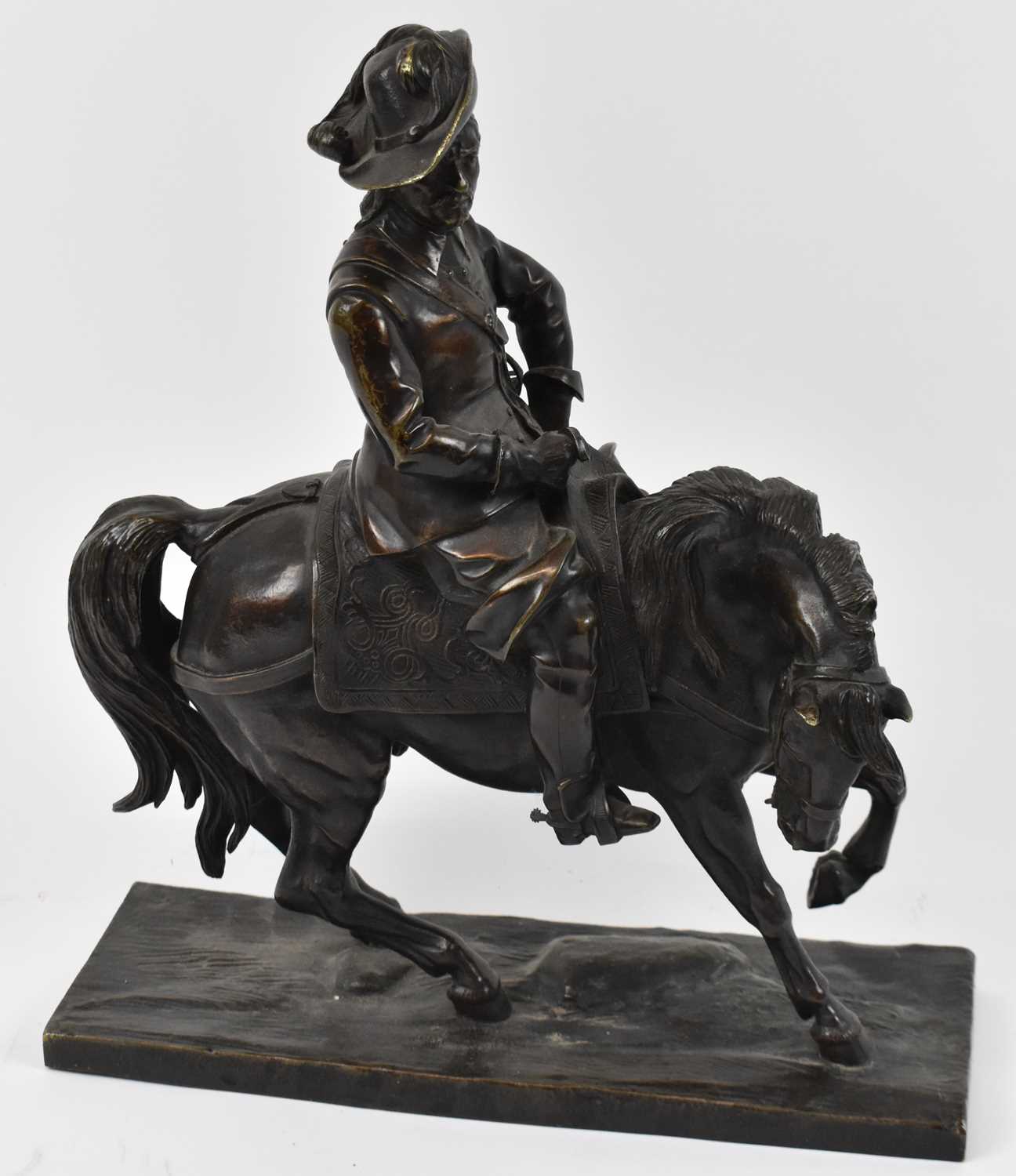 A bronze figure of a cavalier on horseback, indistinctly signed to underside of base, height 38cm,