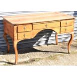 A late 18th/19th century Continental walnut five drawer kneehole writing table on cabriole legs (