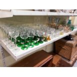 A good collection of predominantly drinking glasses including green stemmed glasses, a set of six