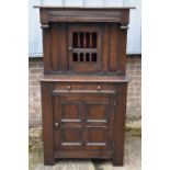 A reproduction oak court cupboard with pierced panel door above drawer and door, width 92cm.