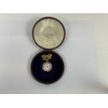 A 14ct yellow gold ladys pocket watch attached to yellow metal bow brooch in fitted case, 3 cms