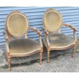A pair of late 19th century French style giltwood elbow chairs (2).