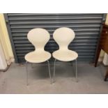 A pair of wood and chrome Rondo dining chairs.