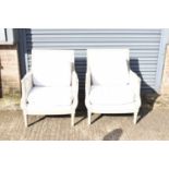 A pair of modern French style cream painted armchairs.