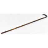 A bamboo walking stick with dark horn handle, the base unscrewing to reveal a brass tipped rod