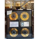 A set of four Elis Presley commemorative gold discs/records in one frame, 'Kentucky Rain', 'In the