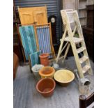 Two vintage folding deckchairs, terracotta pots, a bread bowl, galvanised watering cans and