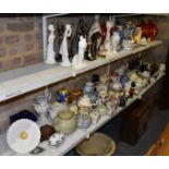 Four shelves of mixed china including teapots, vases, ornaments etc .