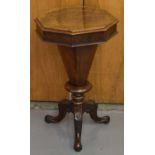 A Victorian walnut 'trumpet' sewing table with octagonal top above tapering central column to