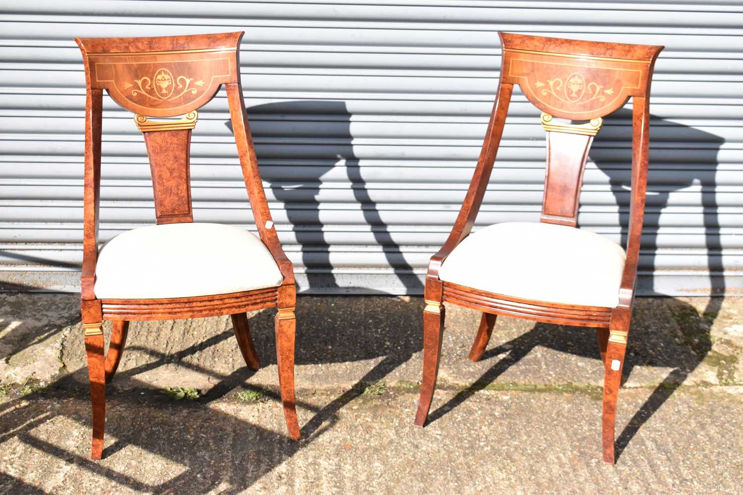 A pair of modern ornate salon chairs.