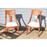 A pair of modern ornate salon chairs.