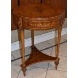 A reproduction circular walnut side table, height 71cm, diameter 50cm.