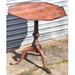 A 19th century mahogany tilt-top table, the octagonal top on tripod supports, the column with