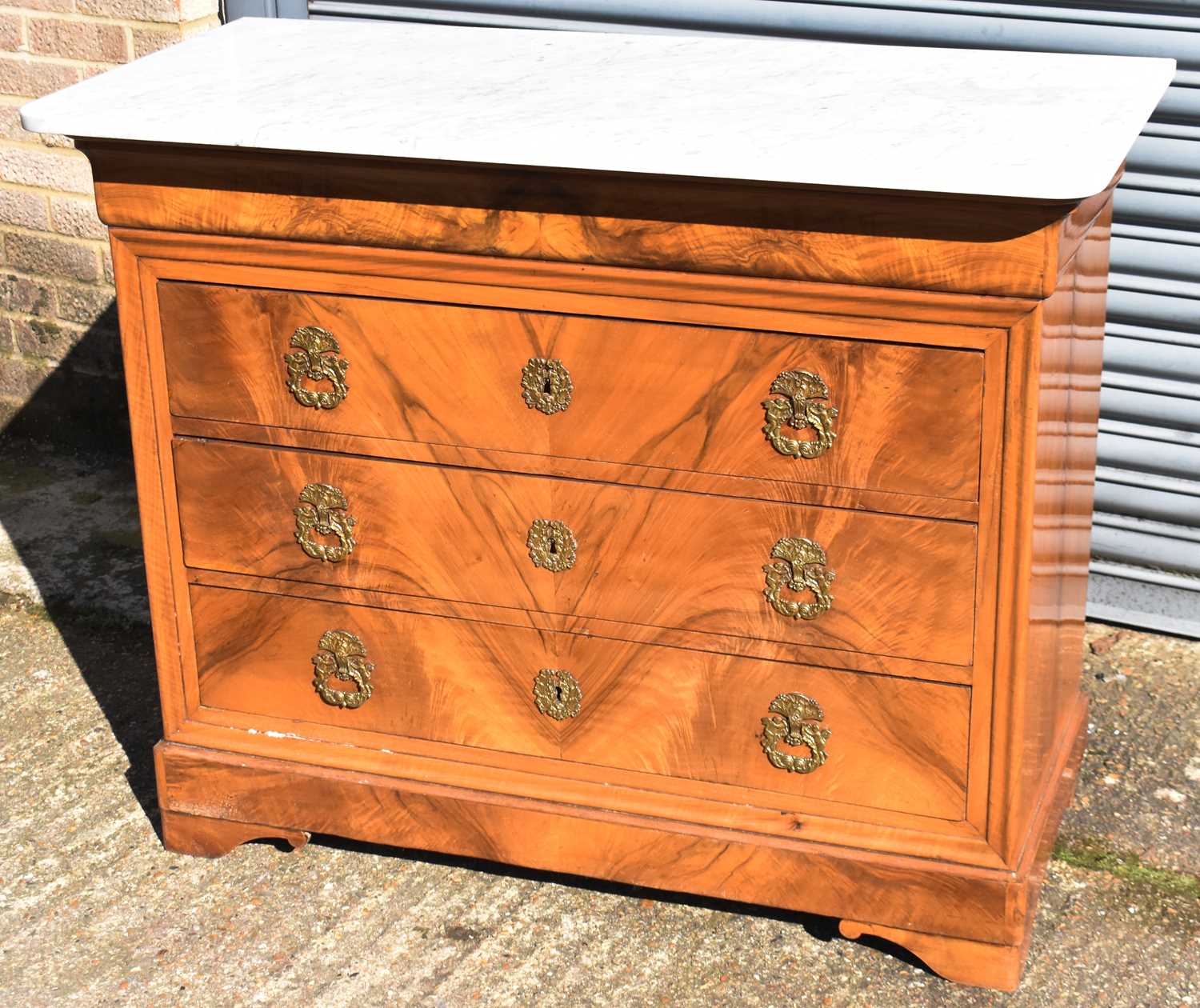 A 19th century Continental walnut chest with white marble top above cushion drawer and three long