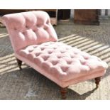 A late Victorian day bed upholstered in pink floral draylon on four turned mahogany legs and