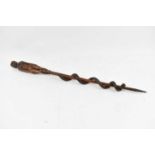 An interesting carved hardwood cane, the upper section with primitive figure of a nude female