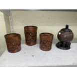 A set of three Oriental bamboo brush pots and a coconut tobacco jar and cover.