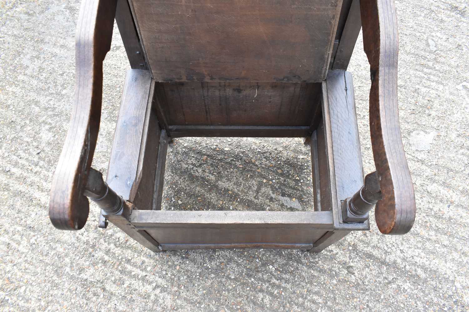 An 18th/19th century oak wainscot type chair with panel back, open arms and hinged seat.Condition - Image 3 of 4