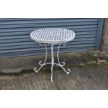 A white painted wrought iron circular garden table, diameter 70cm.